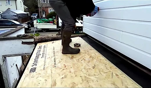 New boarding being laid on a flat roof