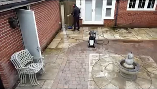 Pressure washing a paved patio with a feature fountain